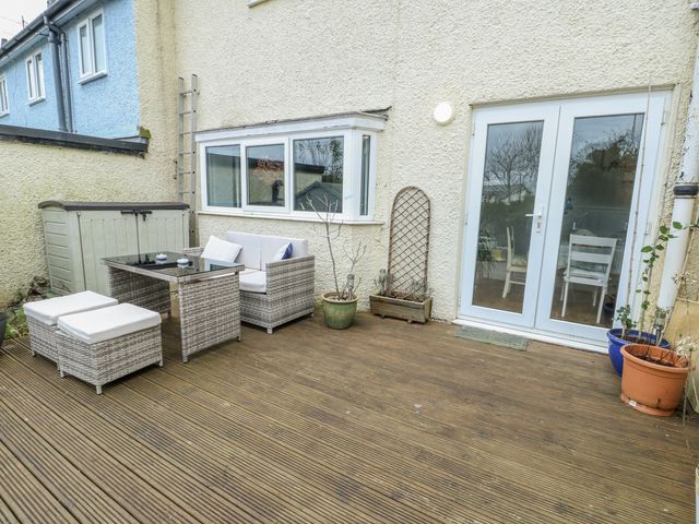 A garden area with seating and a table at 16 Ffordd Meigan Beaumaris