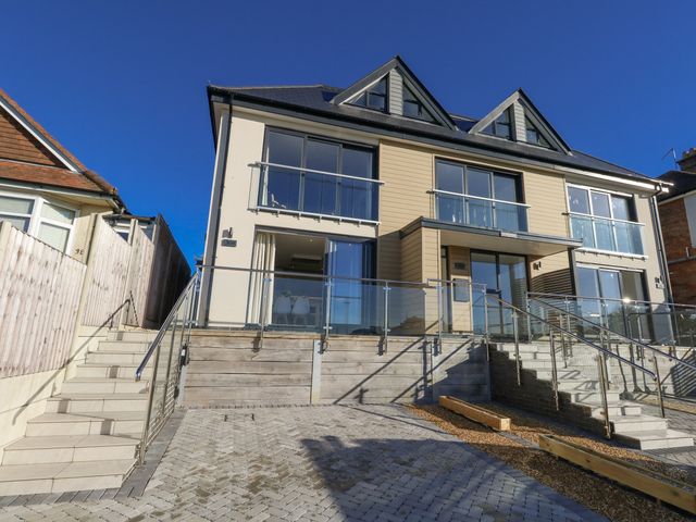 A modern building with balconies and stairs at Seafern House 36B in Poole