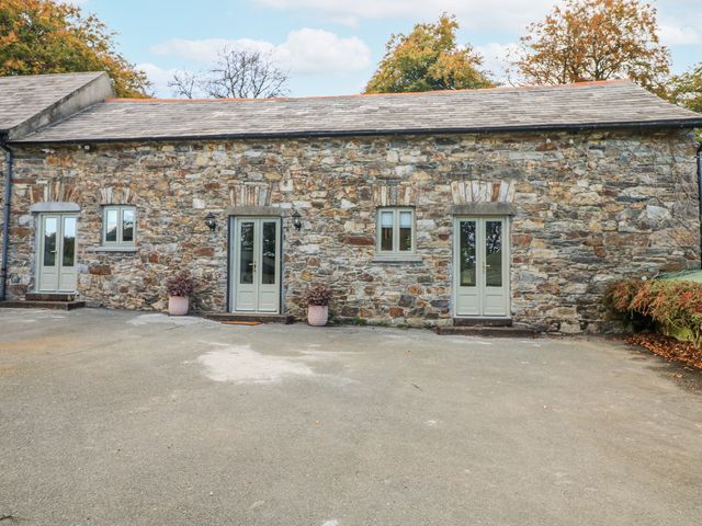 An exterior view of a stone building with doors and windows at Robins Rest at The Lodge Kilmacthomas
