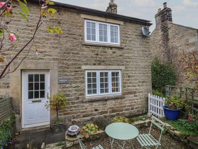 An outdoor view of a stone house with garden furniture at Daleholme in Barnard Castle