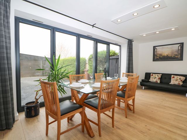 A dining room with a table and chairs at 7 Oaks Track in Carshalton