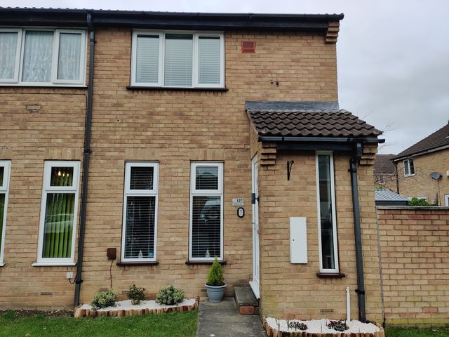 An exterior view of a house with windows and brick walls at 127 Bellhouse Way in York