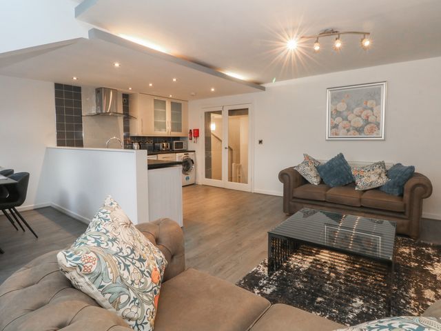 A living room with a sofa and coffee table at 32B Bank Street in Rossendale