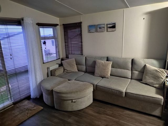 A living room with a sofa and cushions at 237 - Penkalick in Padstow