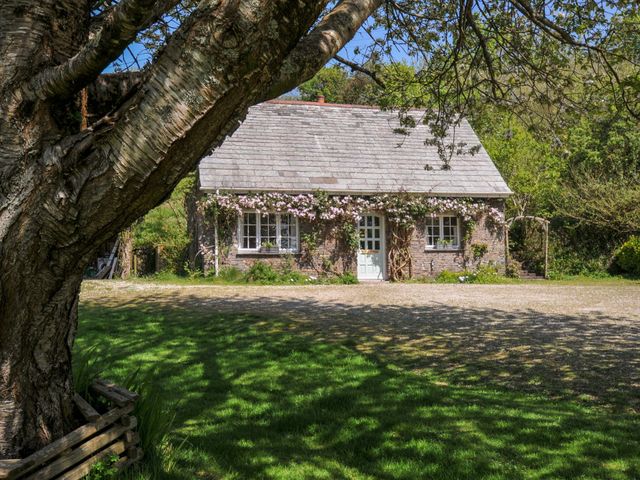 A cottage with a garden and trees at Copper Mine Cottage in Trelill near Port Isaac
