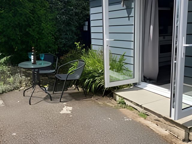 An outdoor seating area with a table and chairs at The Nook 