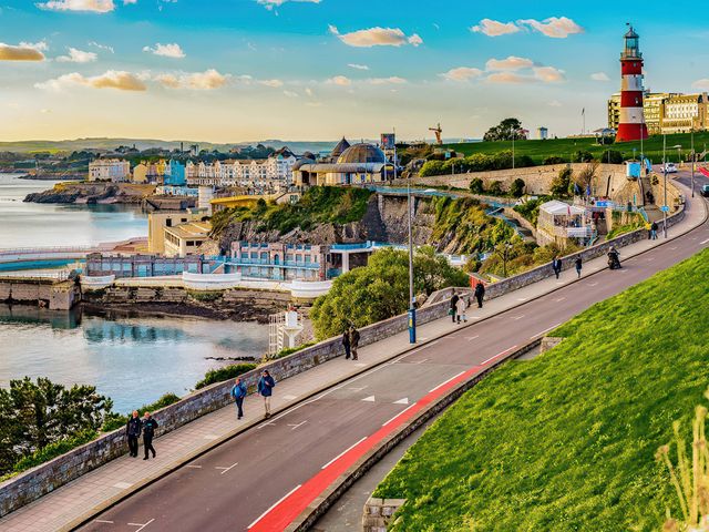 A view of a seaside area with a lighthouse and pathway at 