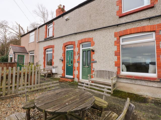 A house with a garden and seating area at 3 Bay View Terrace in Llandegfan