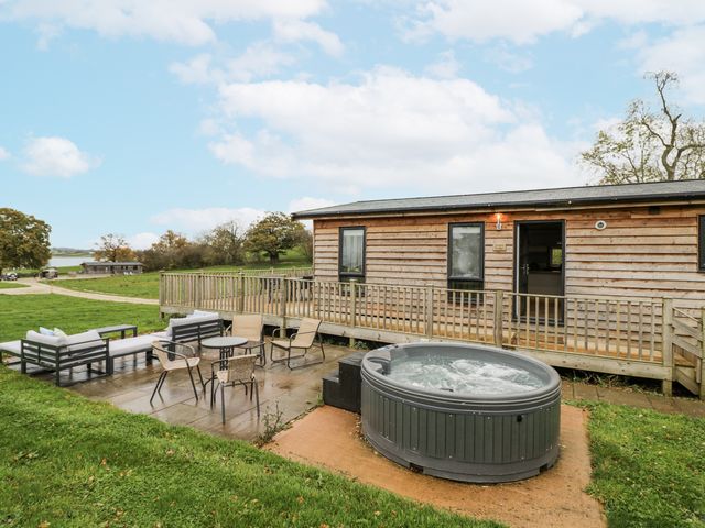 An outdoor area with hot tub and seating at Willow Lodge in Admaston near Abbots Bromley