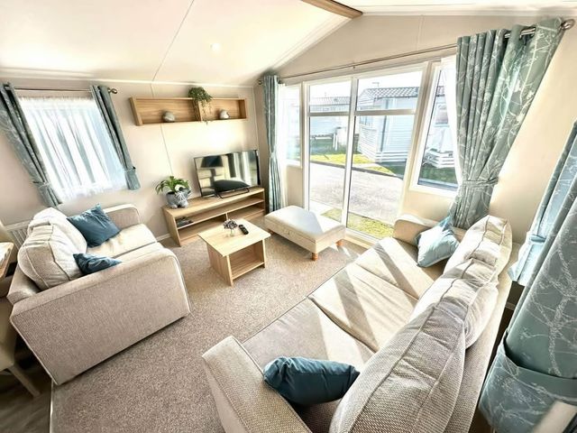 A living room with a TV and a coffee table at The Old Barn in Manchester