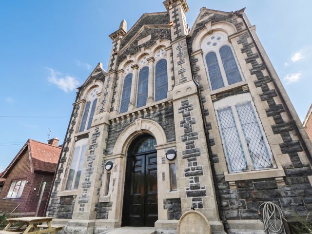A church building with multiple large windows at Capel Llani Llanidloes