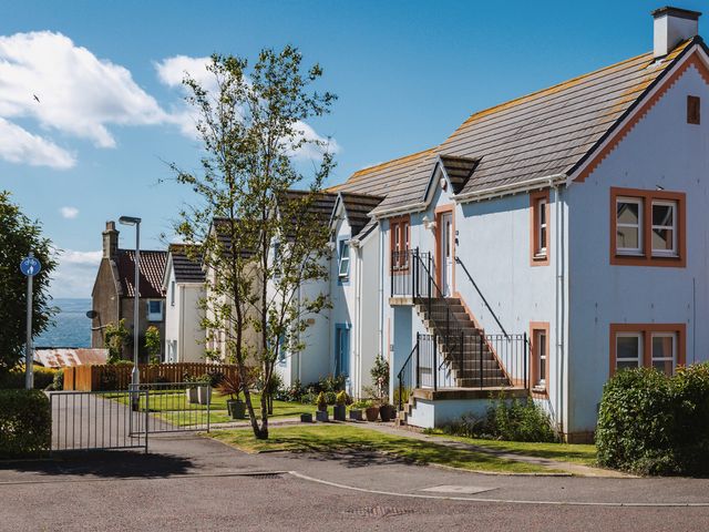 A row of houses with stairs and plants outside at Acorn Court