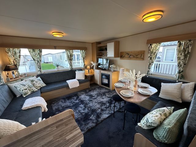 A living room with a sofa and dining table at the property