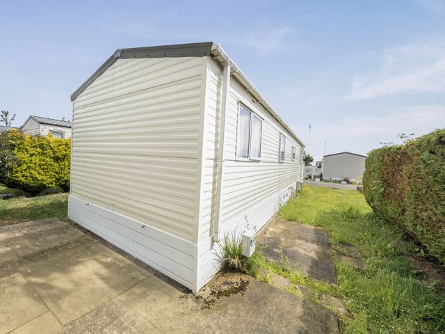 An exterior view of a mobile home at Mersea Beach Retreat in Colchester
