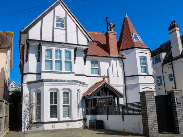 A house with multiple windows and a fence at The Beach House in 
