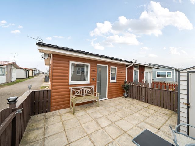 A cabin with outdoor seating area at 38A Bridlington