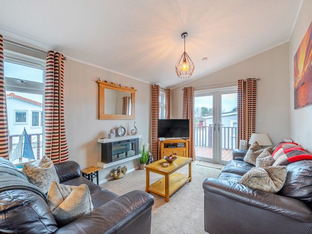 A living room with a television and sofa at 311 Bridlington