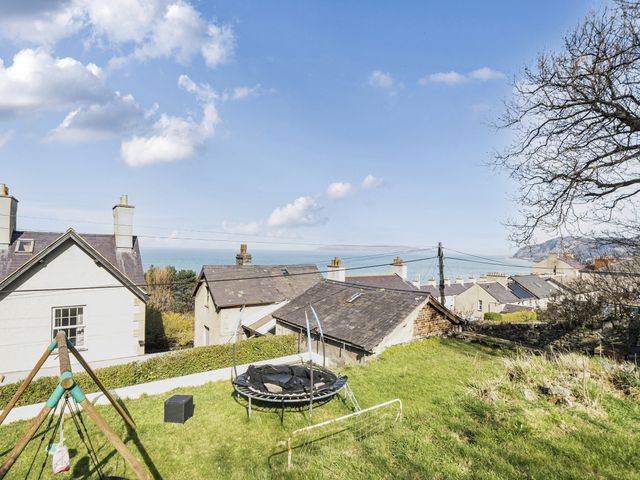 An outdoor view showing houses and a trampoline at Sea View Escape in Penmaenmawr
