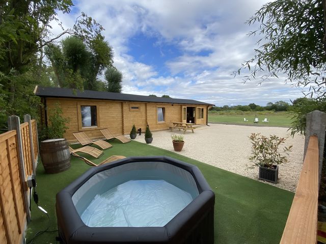 An outdoor area with a hot tub and sun loungers at Cotswold Nights Away 1 in Evesham