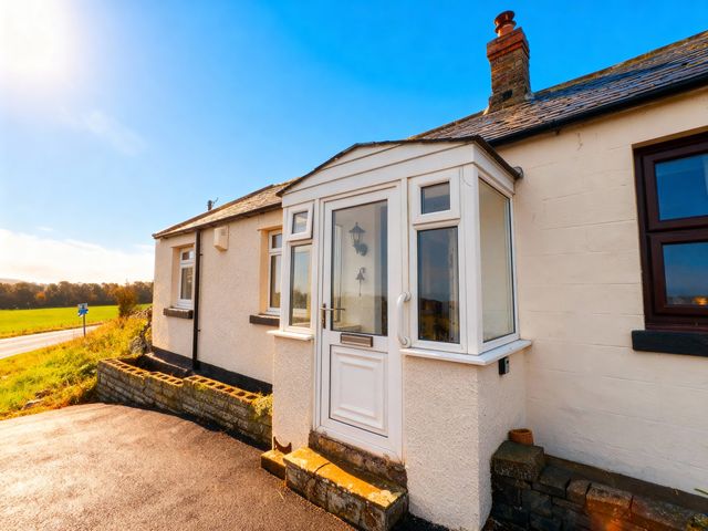 A front porch with a door and windows at 1 Sunny Brae in Embleton