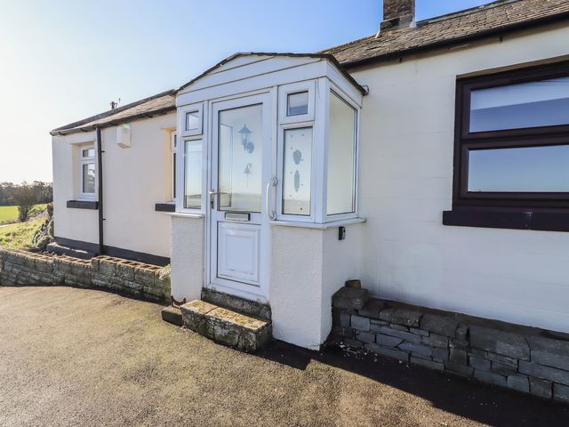 A cottage with a porch at Harry's Cottage in Embleton