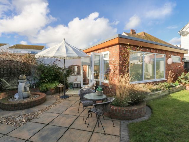 A garden with a patio area and seating at The Summerhouse in Llandudno
