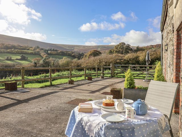 A table set with tea and cake outdoors at Dairy Cottage Bullhornstone near South Brent