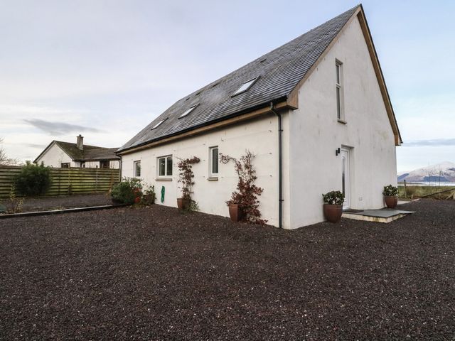 A house with gravel area and planters at Lurach House in Port Appin