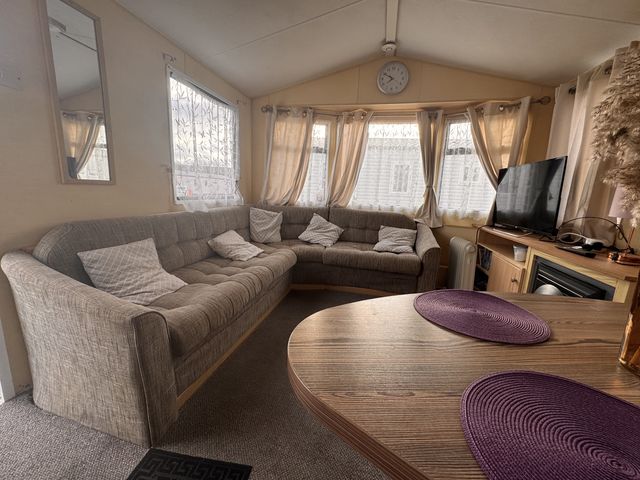 A living room with a sofa and television at 29 Laburnham Court in Fleetwood
