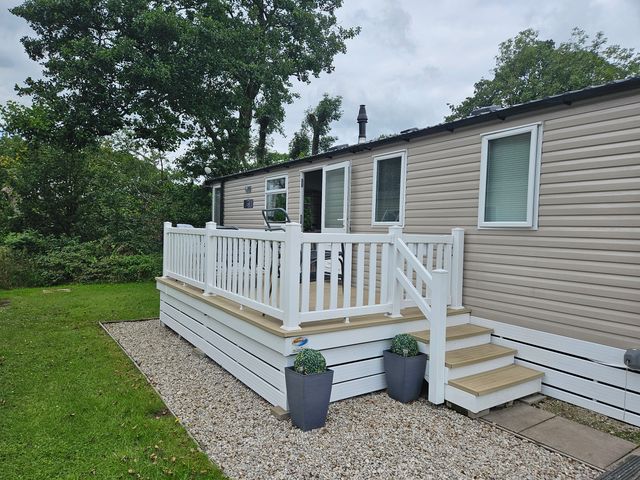 A holiday home with a deck and steps at Woodland View