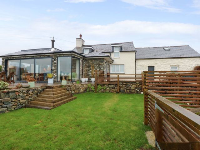 A house with a garden and steps at Bryn Mor Cottage in Mynytho near Llanbedrog