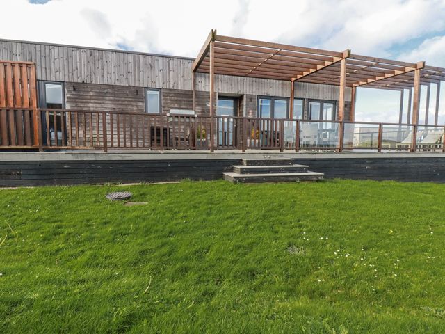 An outdoor area with wooden decking and a pergola at Adelaide in Redruth