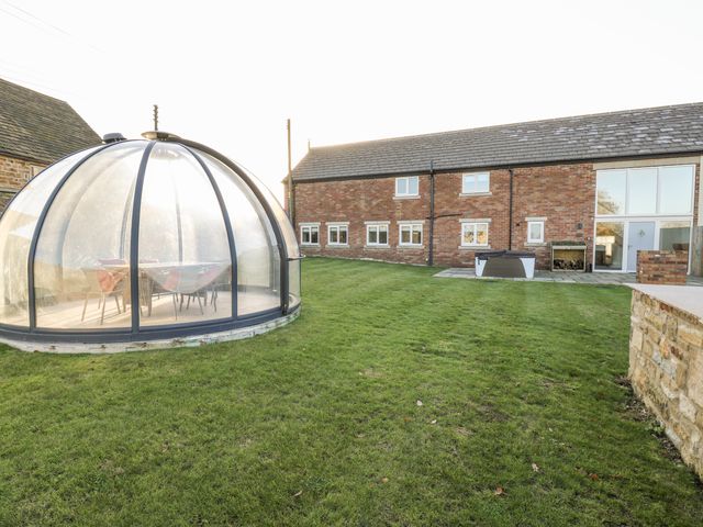 A garden with a dome structure and a house at The Robins Nest in 