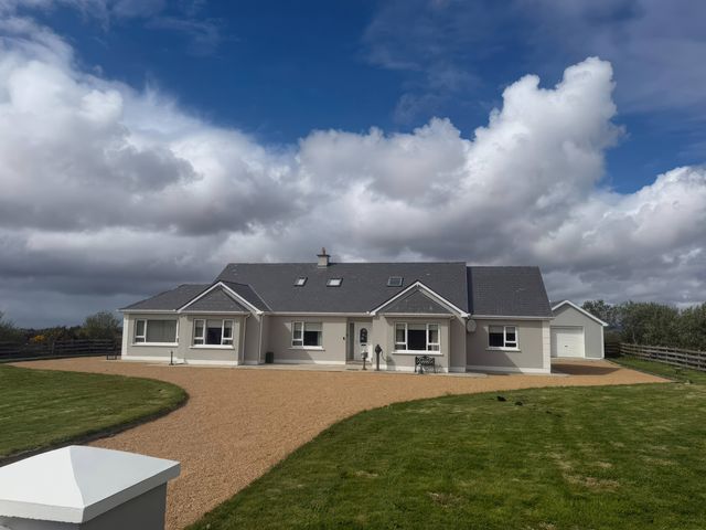 A house with a garage and driveway at Storey and Half House near Annagry, County Donegal