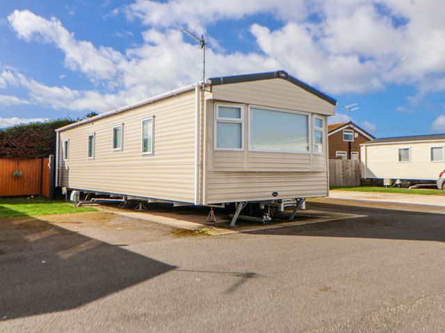A caravan parked on pavement at St Michaels Caravan Park - 236 Towyn