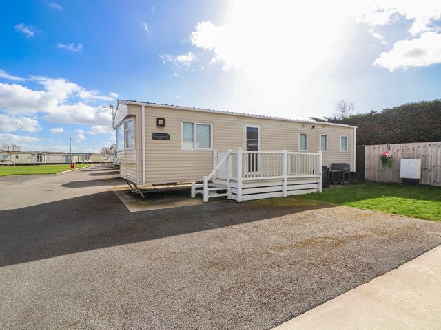 A caravan with a deck in St Michaels Caravan Park - 236 Towyn