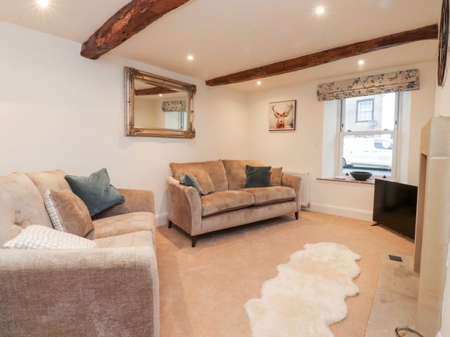 A living room with a sofa and armchair at Cobble Cottage Clitheroe