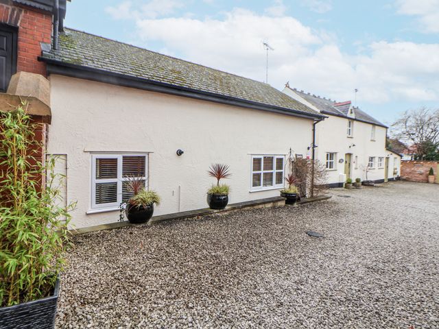 An exterior view of a building with windows and plants at The Stables in Prestatyn
