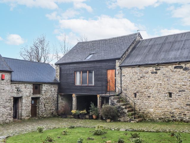 A building with stone walls and stairs at Swallows Nest Widecombe-in-the-Moor near Postbridge