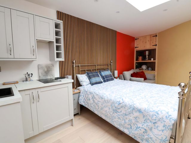 A bedroom with a bed and kitchenette at Skylights in Chester