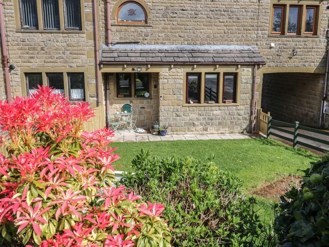 A building exterior with plants and seating area at Underview in Jackson Bridge