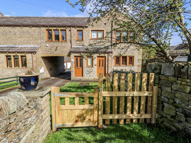 A house with a gate and fence at Moorview in Holmfirth