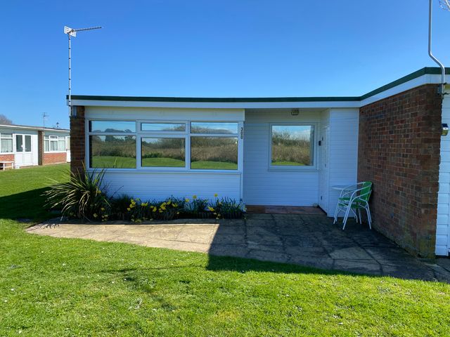 An exterior view of a property with flowers and chairs at 300 California Sands, California, Norfolk