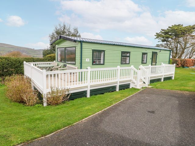 A caravan with decking and steps at Swanage Coastal Park Caravan in Swanage