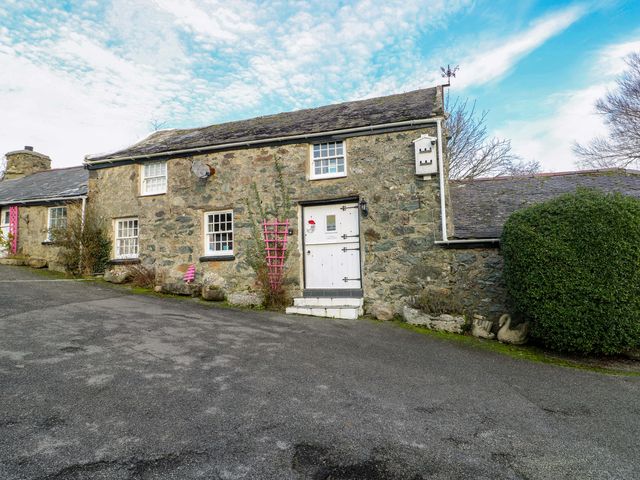 A stone house with front door and windows at The Mill in Holyhead