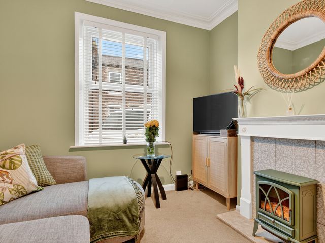 A living room with a couch and television at Windsor House in York