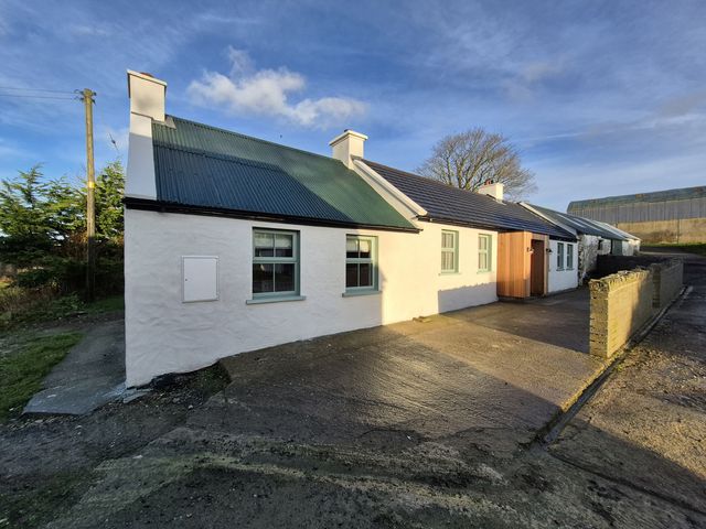 A house with a green roof and driveway at Annie’s Farm Cottage near Londonderry Northern Ireland
