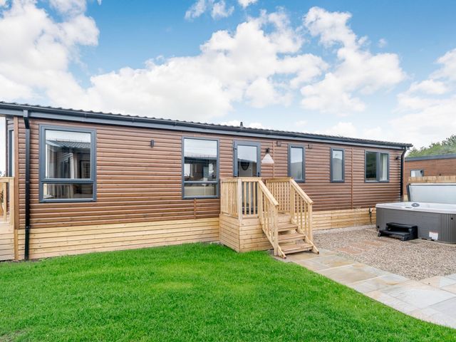 An outdoor area with steps and a hot tub at Spindle Spa (Pet) Carlton Miniott near Thirsk