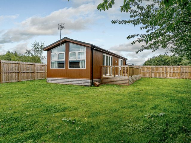 A house with a deck and fenced yard at Cherry Tree in Carlton Miniott near Thirsk