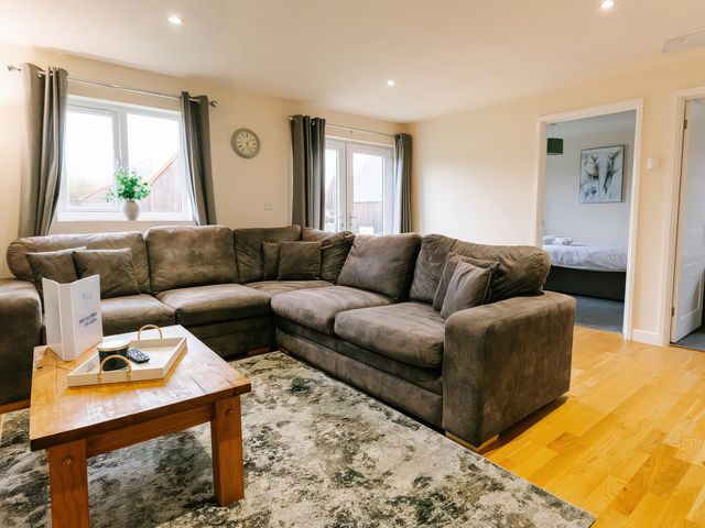 A living room with a sofa and coffee table at Aspen Lodge in Brigg